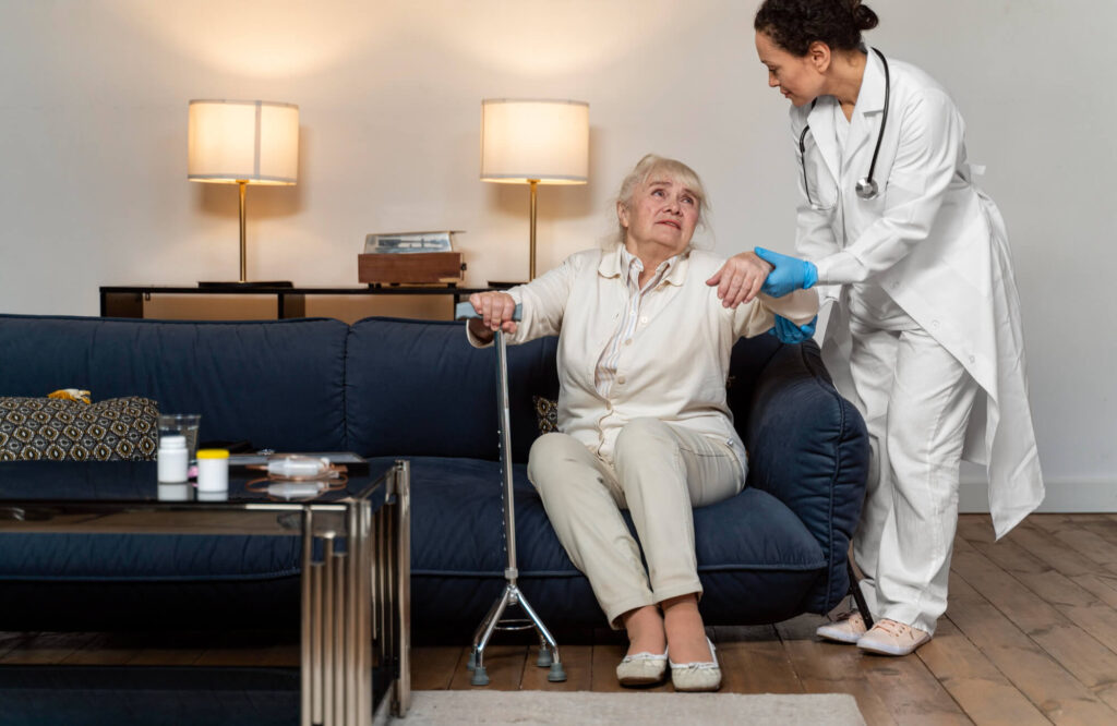 Senior caregiver helping an elderly woman age safely at home in Brooklyn NY